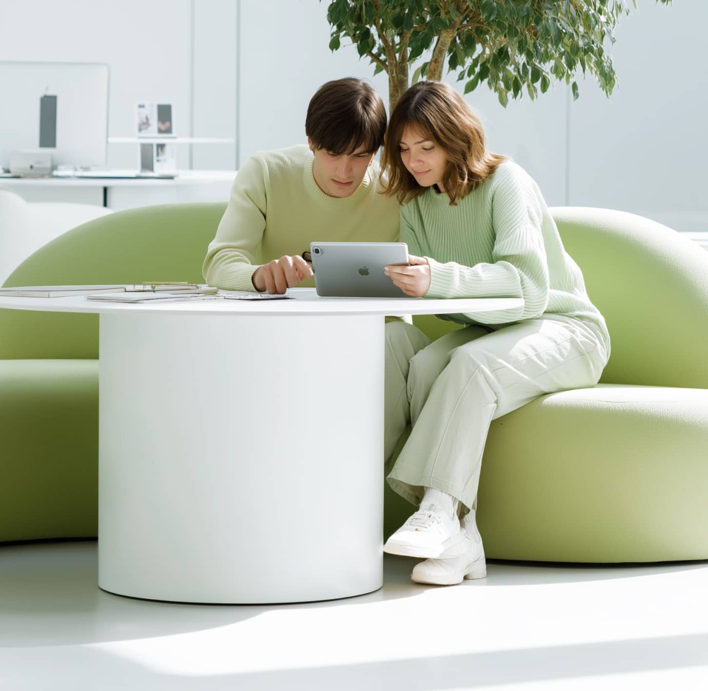 Couple Using Tablet In Modern Minimal Workspace