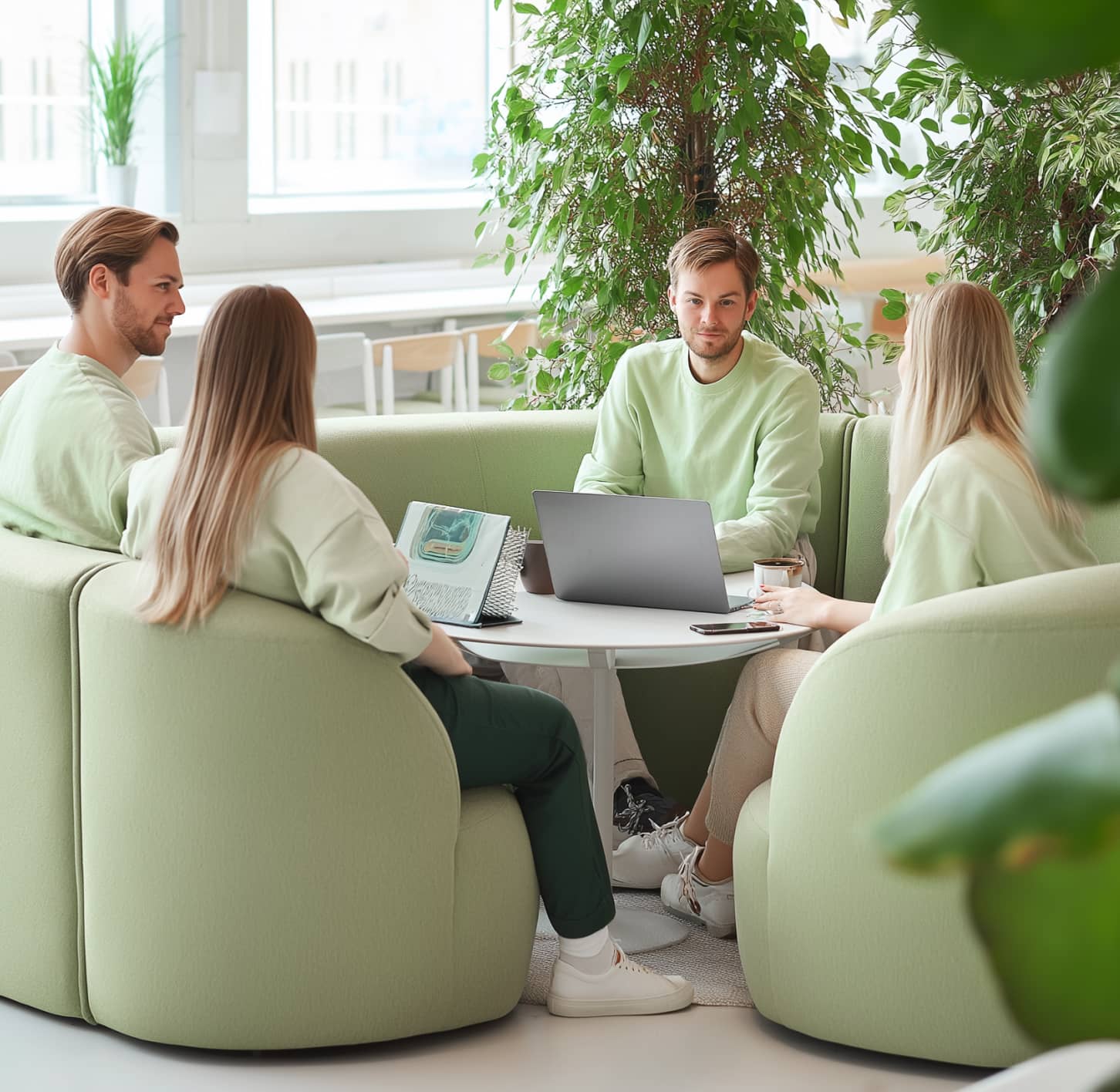 Productive Team Huddle In A Green Workspace 
